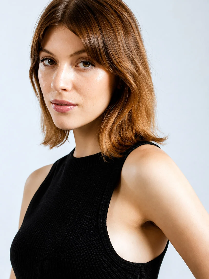 Black sleeveless knit top on a model